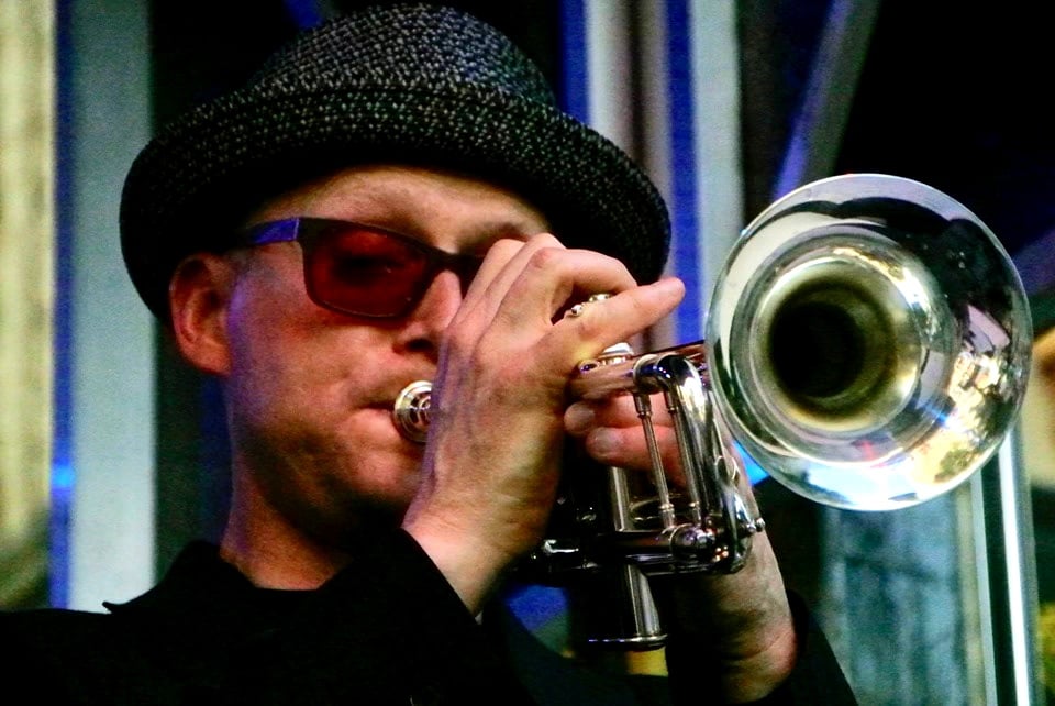 Trumpeter posing with his instrument