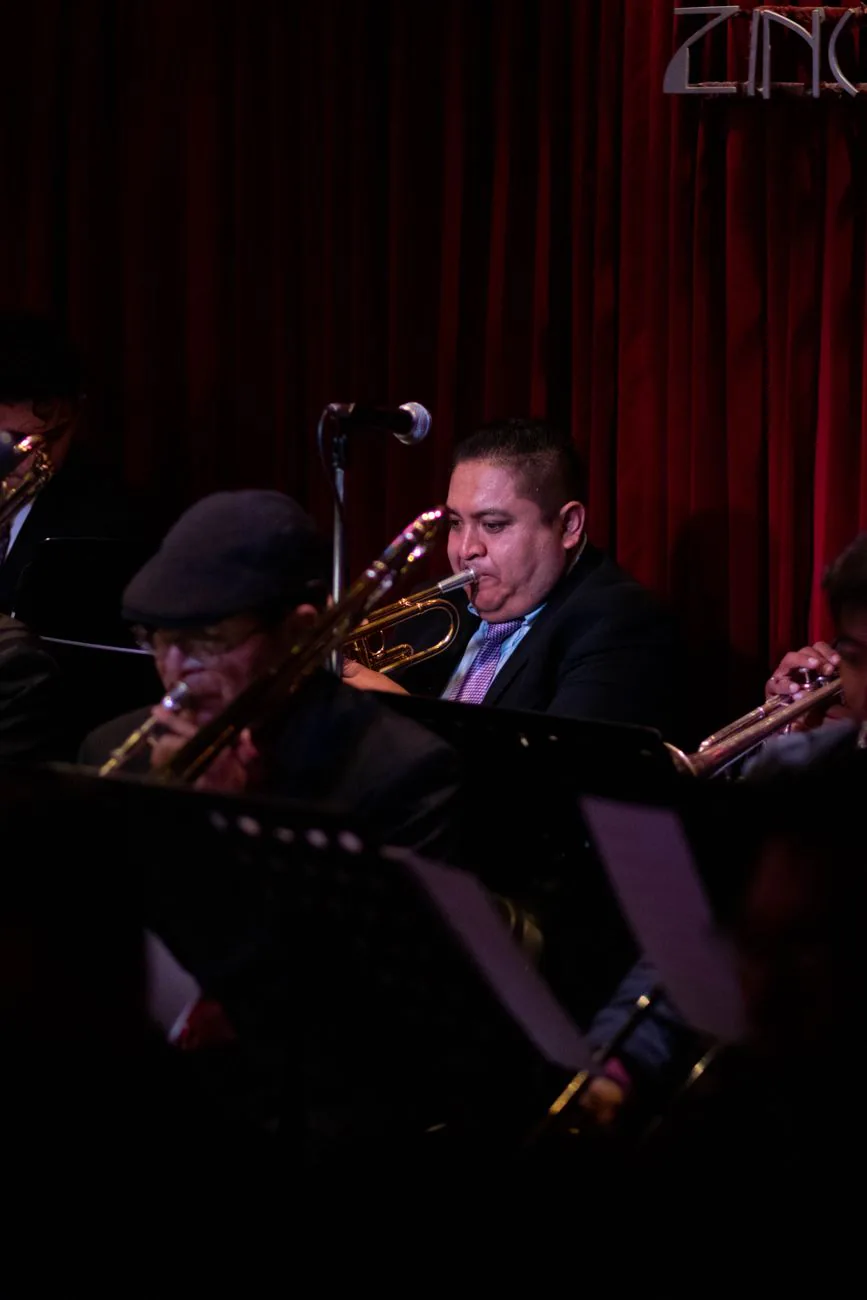 Jazz musicians performing live under warm stage lighting