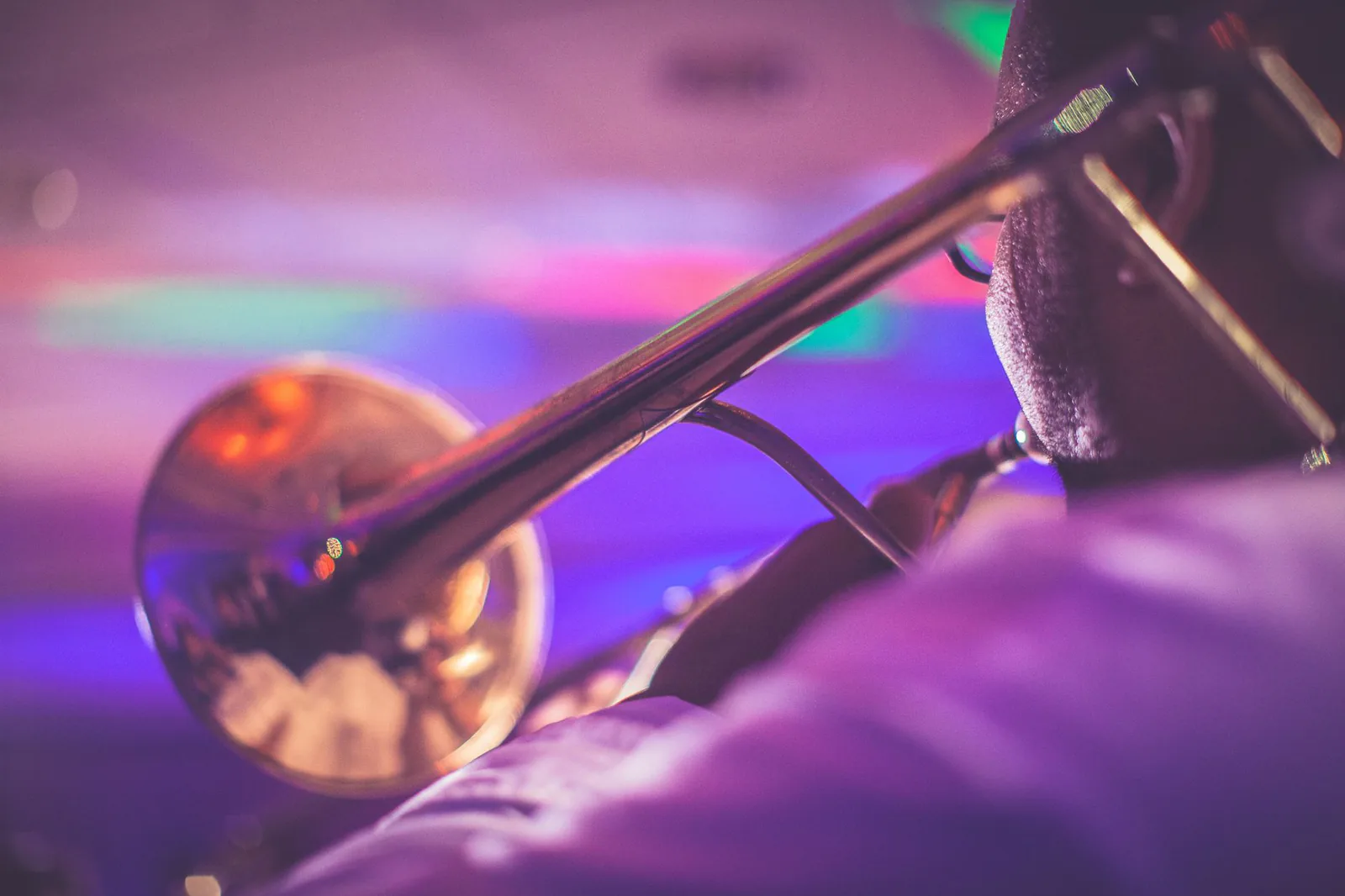 Live jazz band performing on stage with saxophone, bass, and piano